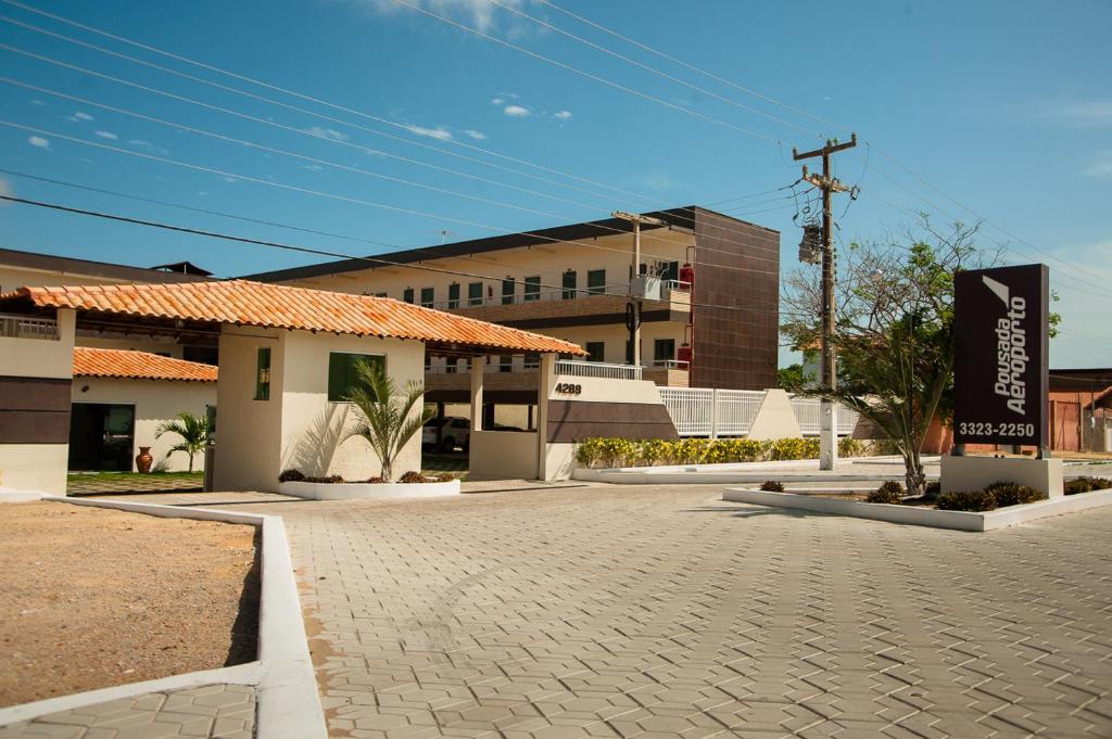 a parking lot in front of a building at Pousada Aeroporto in Parnaíba