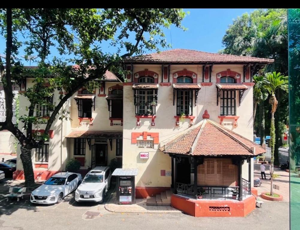 a building with cars parked in front of it at Nhà Khách TW in Hanoi