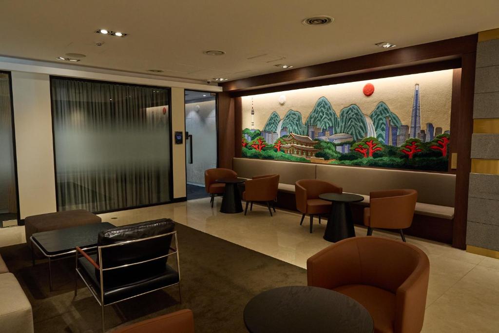 a waiting room with a large painting on the wall at Acube Hotel Dongdaemun in Seoul