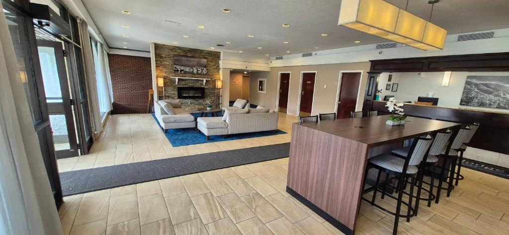 a kitchen and living room with a table and chairs at Quality Inn & Suites in Sydney