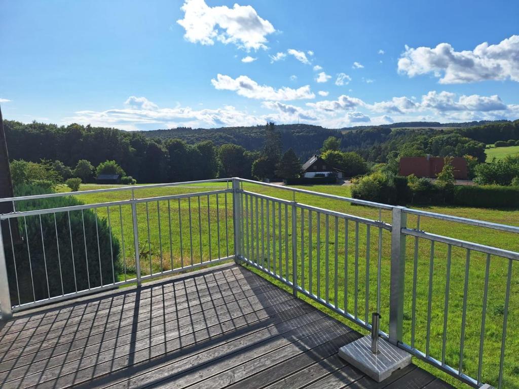 a balcony with a view of a field at Haus Schönblick in Amorbach