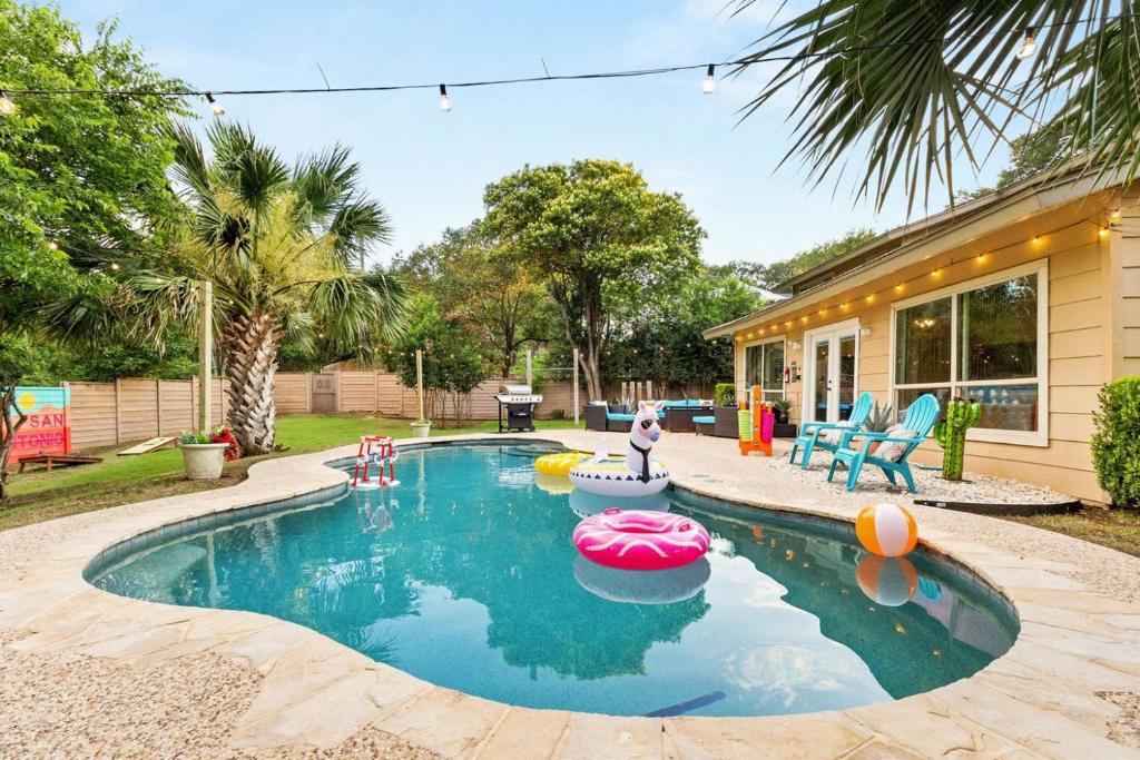 a swimming pool in a backyard with a house at 6BR Pool & Game Arcade Family Dog Friendly in San Antonio