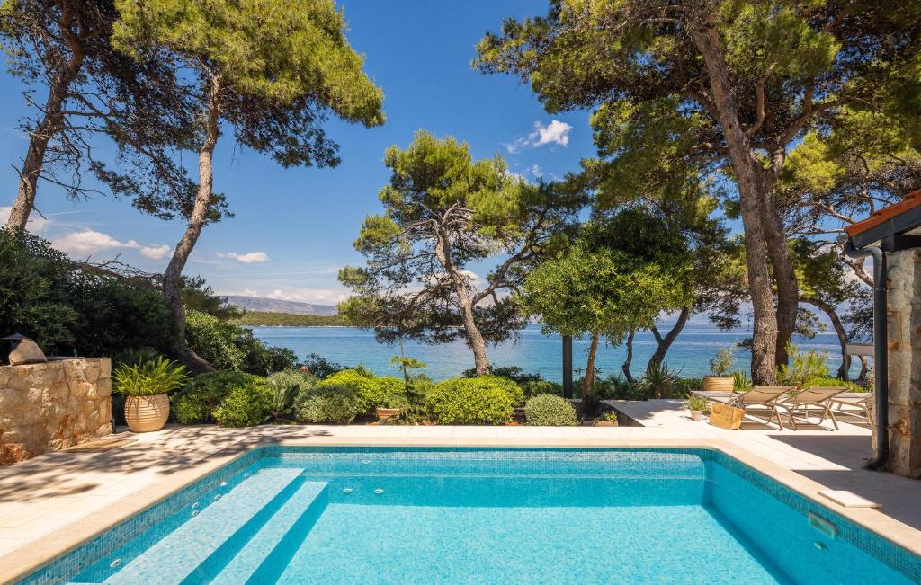 a swimming pool with a view of the water at Villa Ana in Jelsa