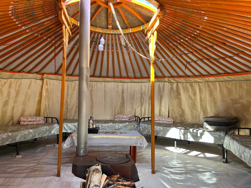 a large tent with two beds and a table at Batzaya Herder Camp in Ulaanbaatar
