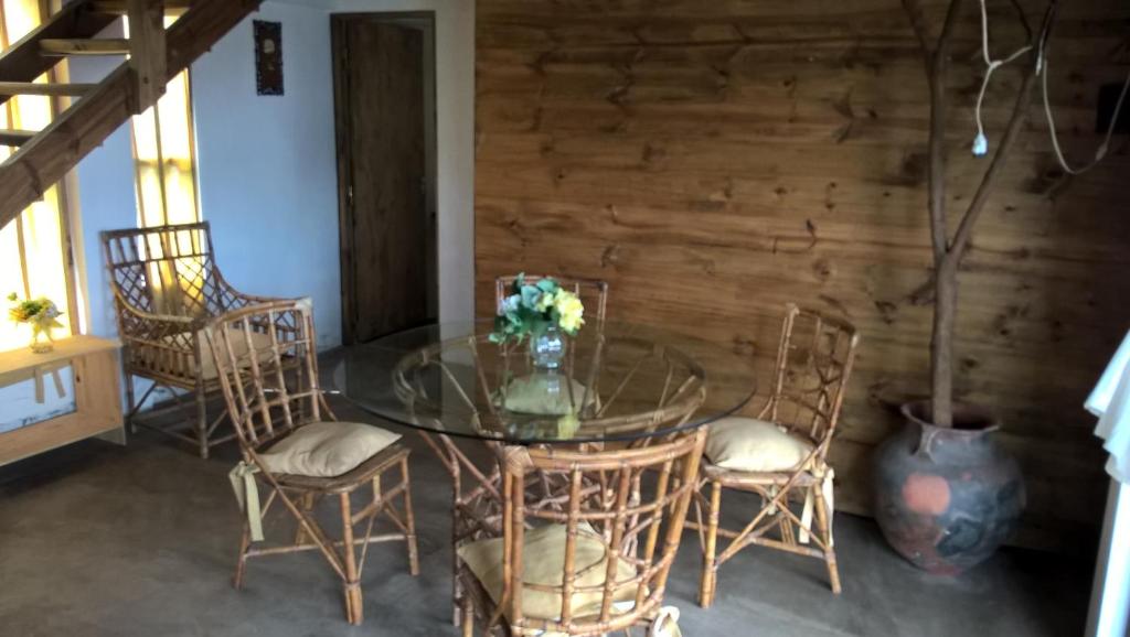 a dining room with a glass table and chairs at Casita Vaqueros in Vaqueros
