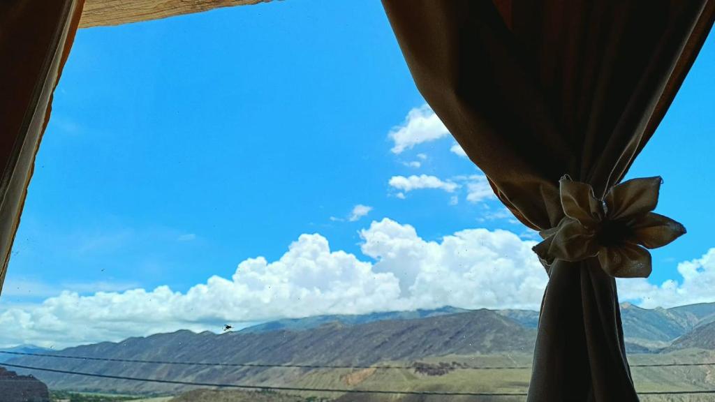 a view of the mountains from a window at Mallma Cabañas in Tilcara