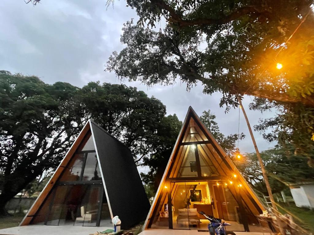 a triangular shaped house with a motorcycle parked next to it at Chalés parada ideal in Guapimirim