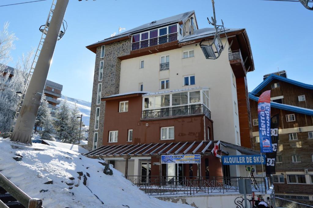a building on a ski slope with snow on the ground at Sierra Nevada Rent Superior in Sierra Nevada