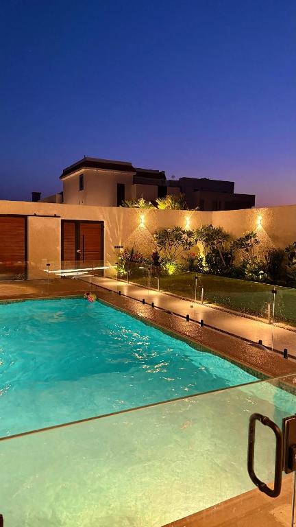 a swimming pool in front of a house at night at رجبانية in Jeddah