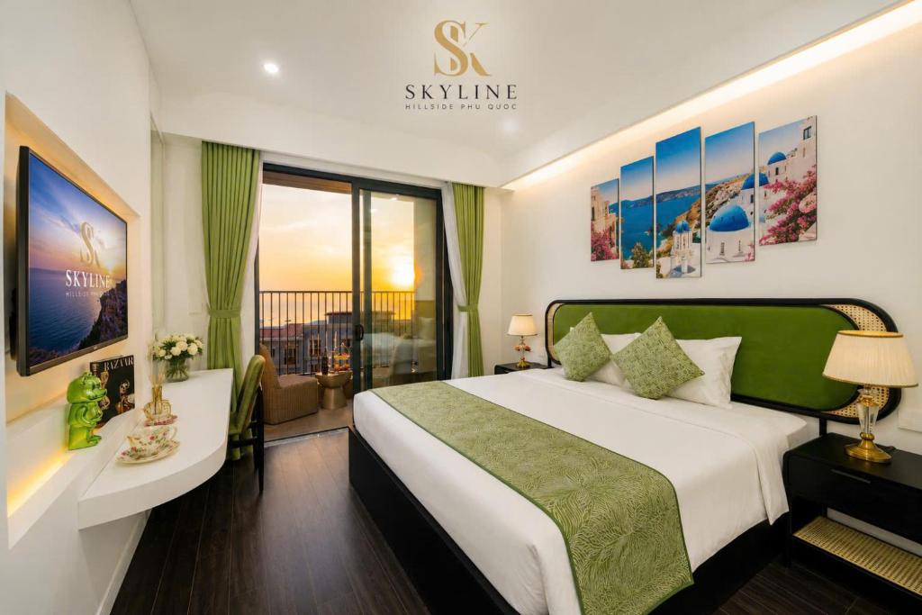 a hotel room with a bed and a large window at Skyline Hillside Apartment Phu Quoc in Phú Quốc