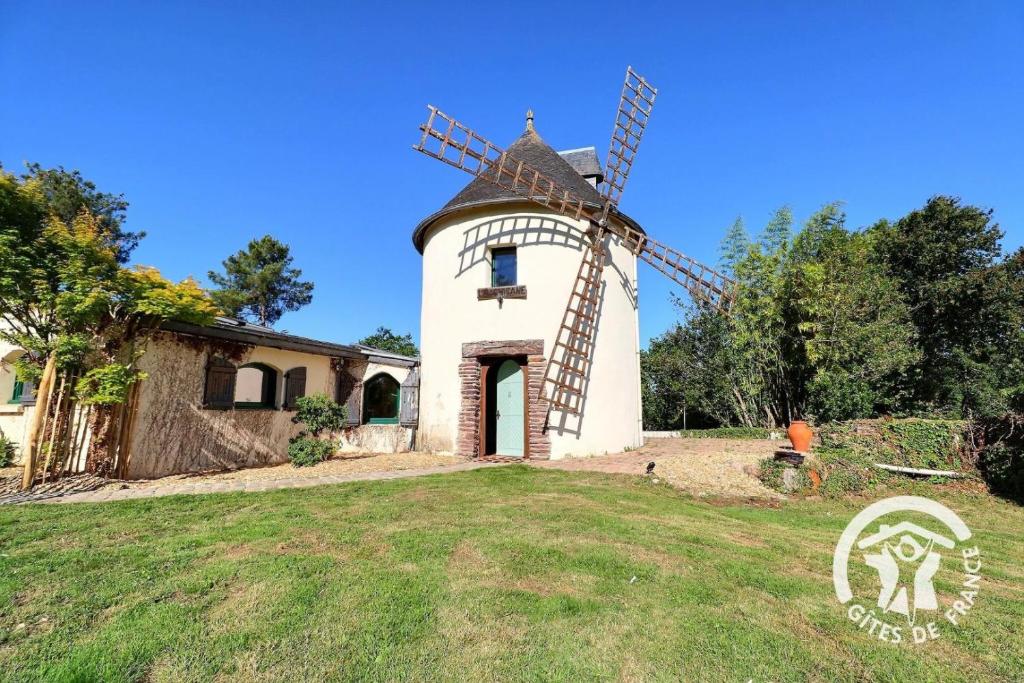 a windmill in the yard of a house at Le moulin de la chicane in Orgères