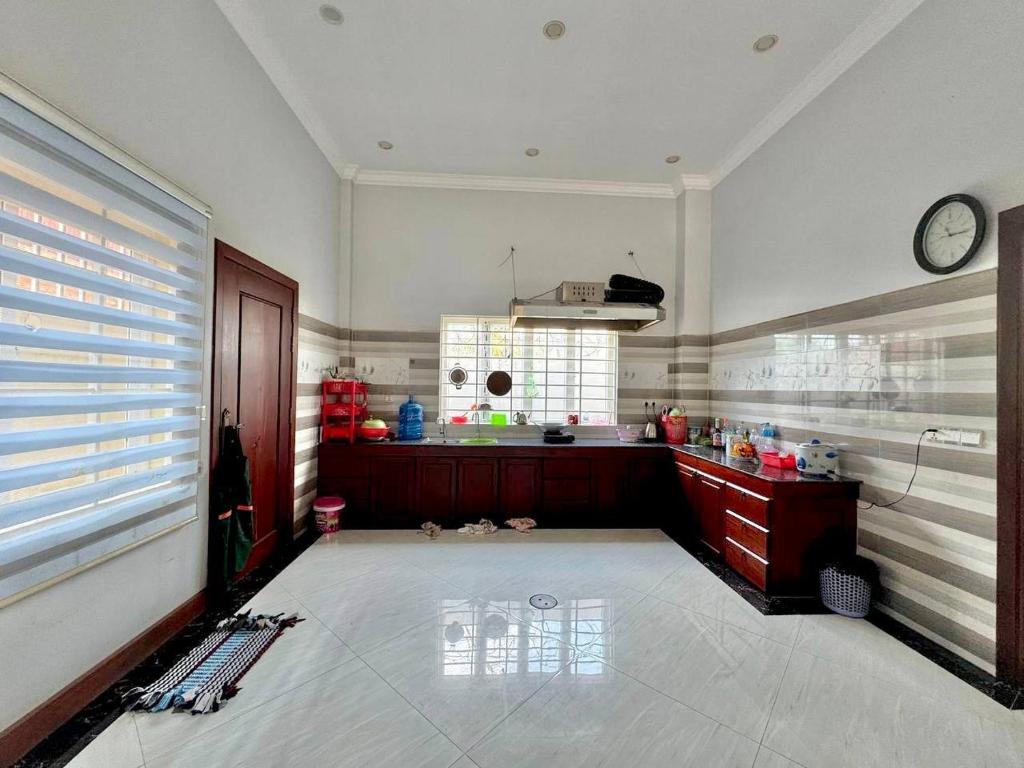 a large kitchen with a clock on the wall at Chakra Rauniyar in Kathmandu
