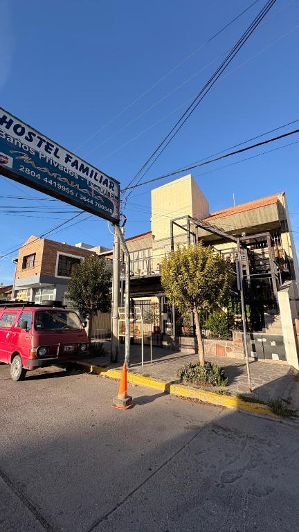 a street sign in front of a building at Hostel Maranata in Puerto Madryn