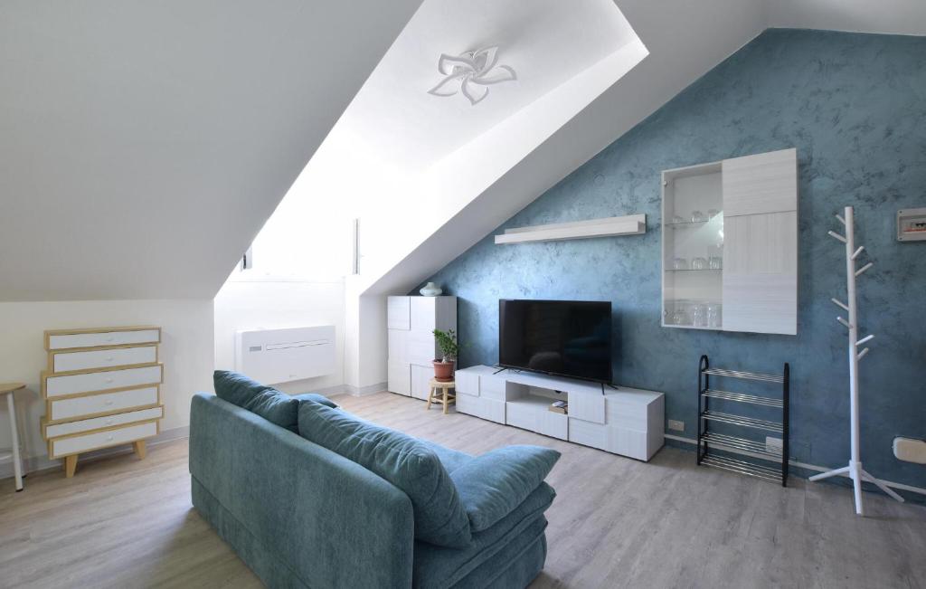 a living room with a couch and a tv at Awesome Apartment In Millesimo With Wifi in Millesimo