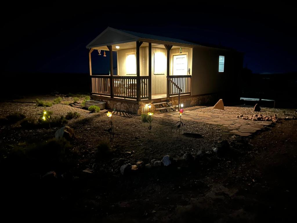 a lit up gazebo with lights in the dark at Grand Canyon tiny homes in Williams