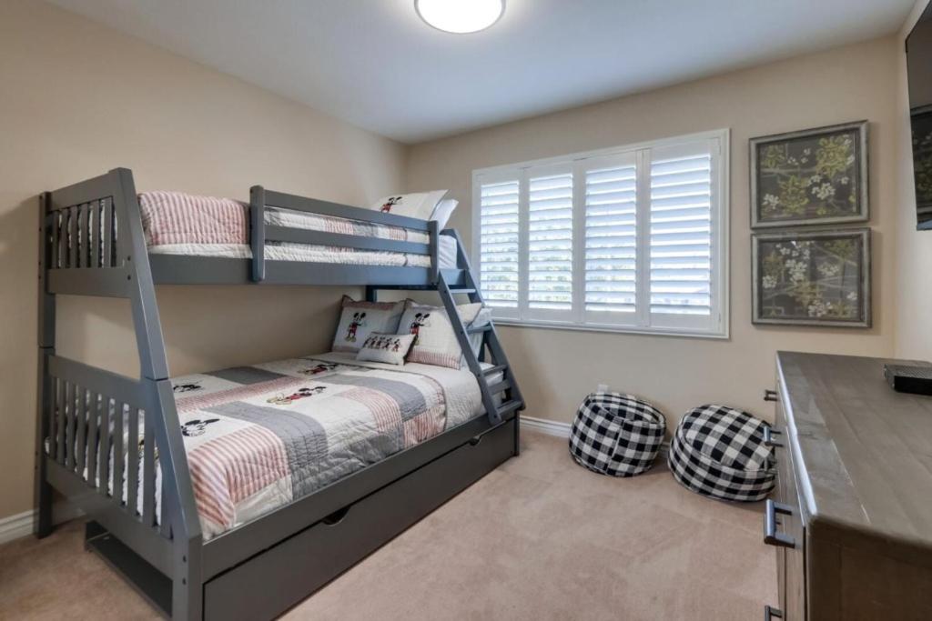 a bedroom with a bunk bed and a desk at Beautiful Backyard Oasis 5 bedroom 3 Bathroom Home in Placentia