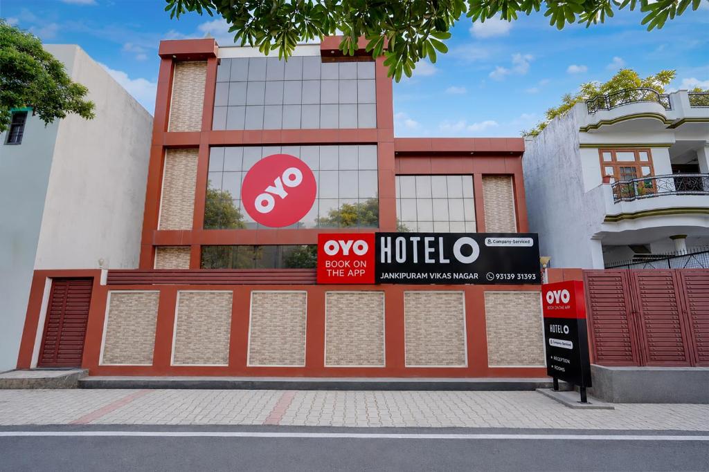 a building with a hotel sign in front of it at Hotel O Jankipuram Vikas Nagar in Lucknow