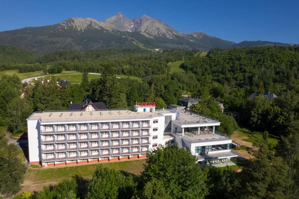an aerial view of a hotel with mountains in the background at Hotel SOREA MORAVA in Tatranská Lomnica