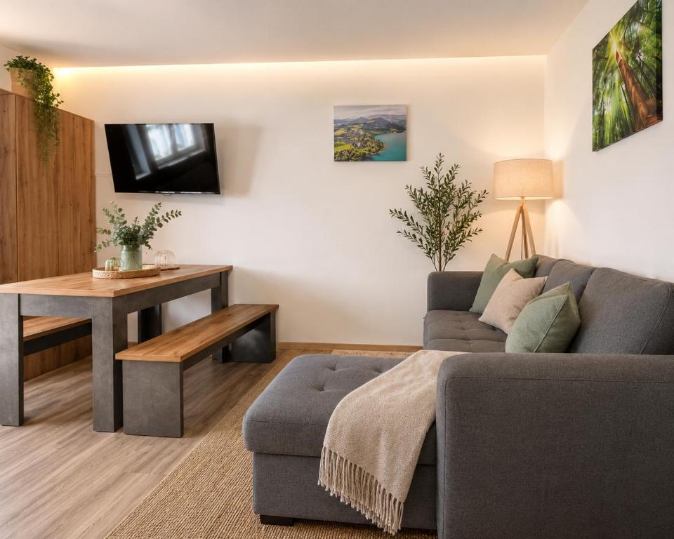 a living room with a couch and a table at Ferienwohnung Melissa in Unter Feuchten