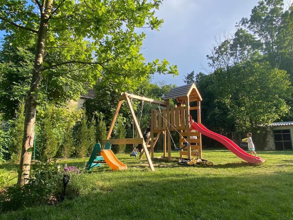 a playground with a slide in a yard at The Gentle Stay in Brunoy