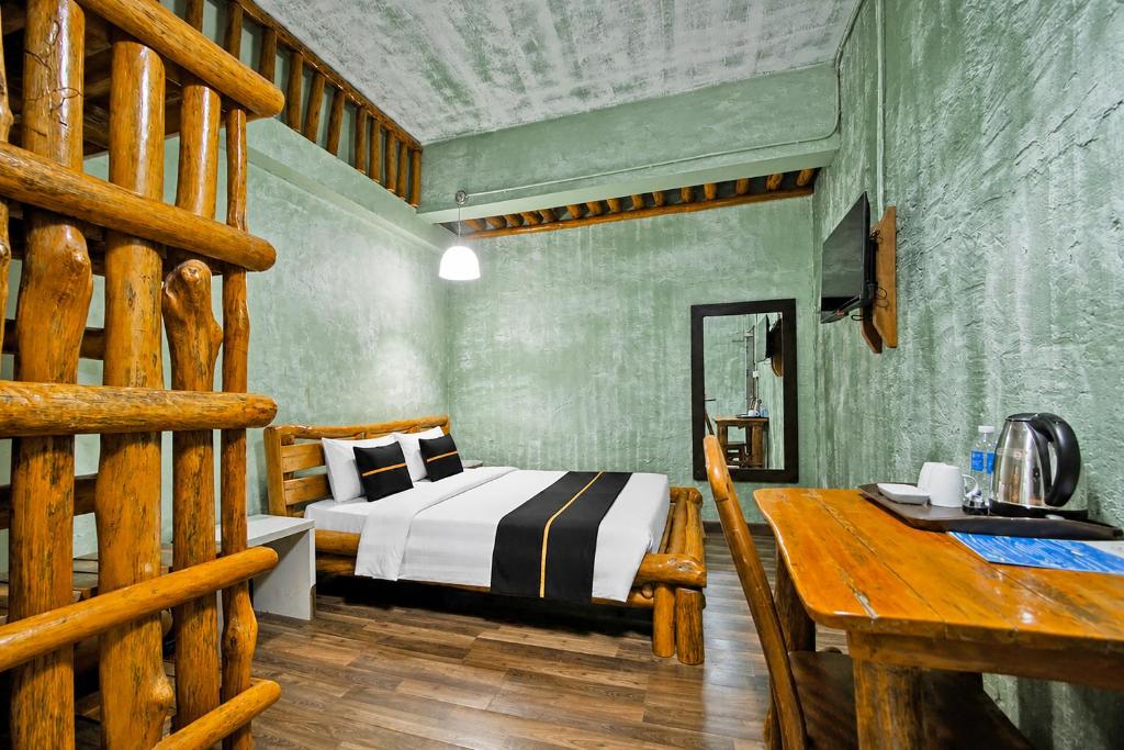 a bedroom with a bed and a desk in it at Townhouse Near Tanjung Batu Formerly 900 Inn in Bintulu