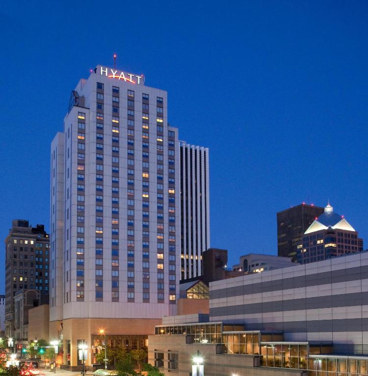 a tall building with a hotel sign on top of it at Hyatt Regency Rochester in Rochester