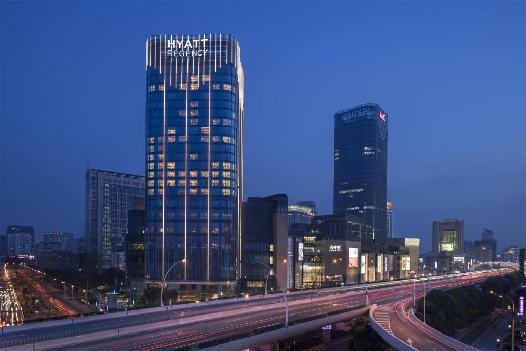 a city skyline with tall buildings and a freeway at Hyatt Regency Shanghai Wujiaochang in Shanghai