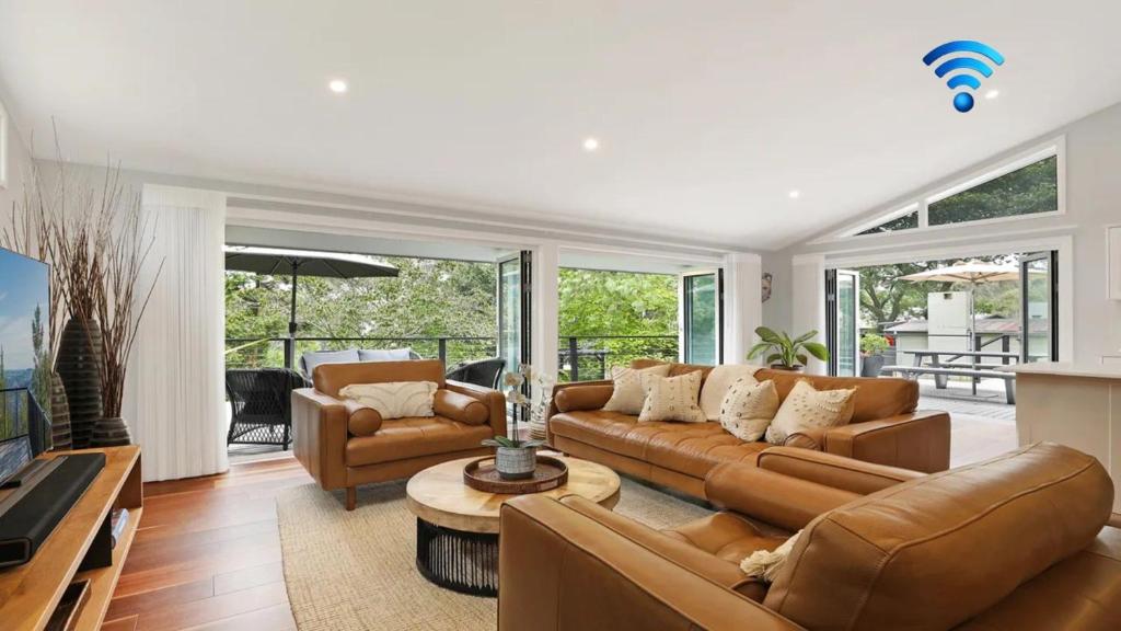 a living room with a couch and a table at Arcadia Cottage in Bowral