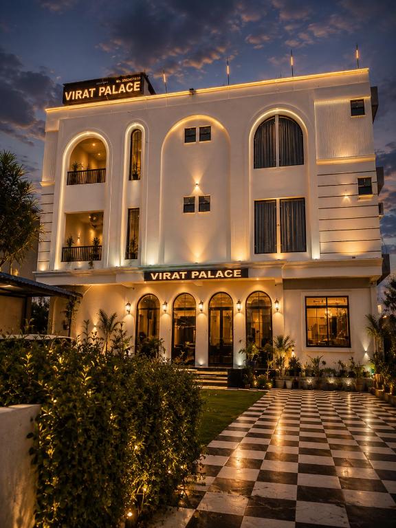 a white building with a checkered floor in front at Hotel Virat Palace 600 From Khatu Shyam Ji in Khātu