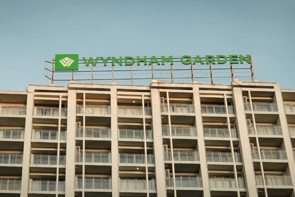 a building with a sign on top of it at Wyndham Garden Manila Bay in Manila