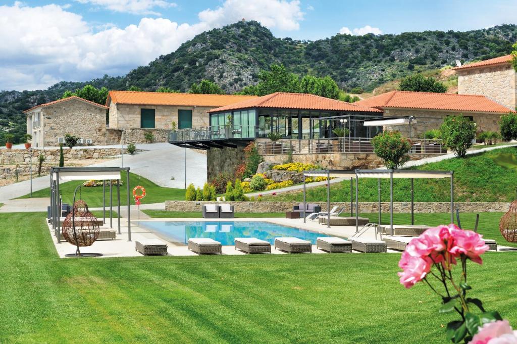 a house with a swimming pool in a yard at Quinta da Terrincha in Torre de Moncorvo
