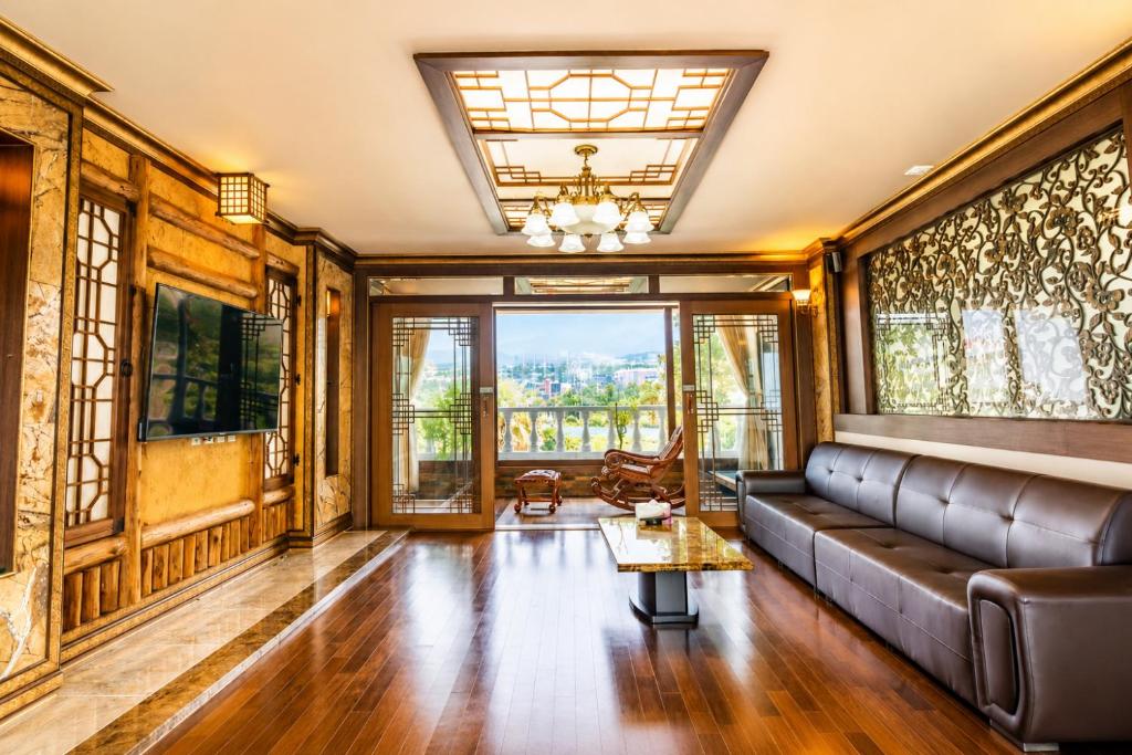 a living room with a couch and a table at Jeju Nine resort in Jeju