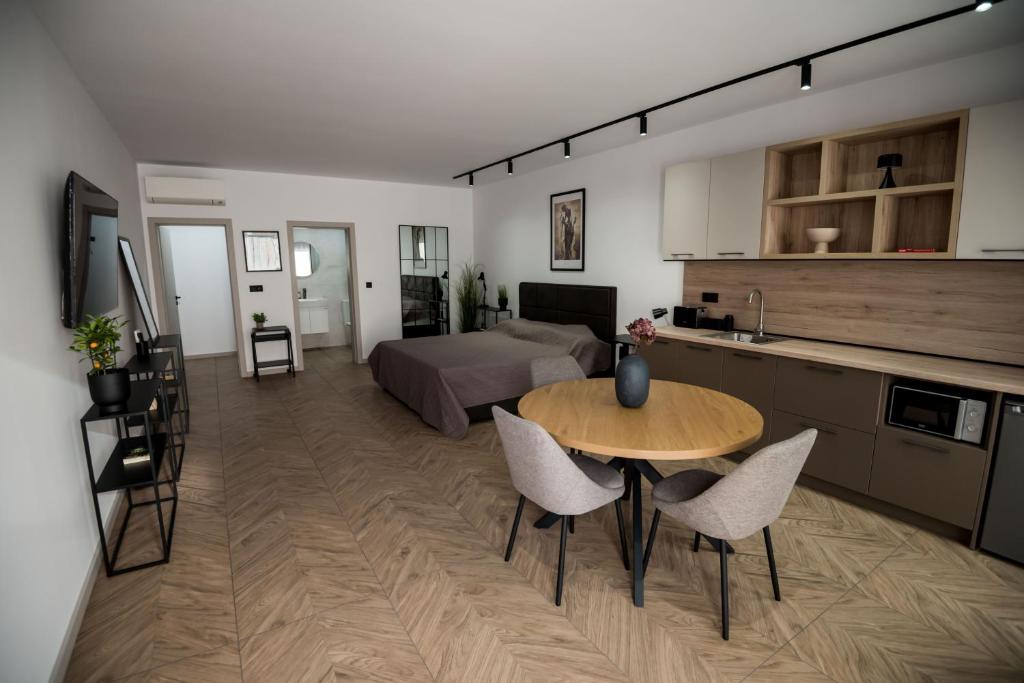 a kitchen and a living room with a table and chairs at Incanto Rentals in Silistra