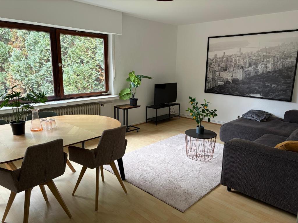 a living room with a table and a couch at Village Apartment Rheinbreitbach in Rheinbreitbach
