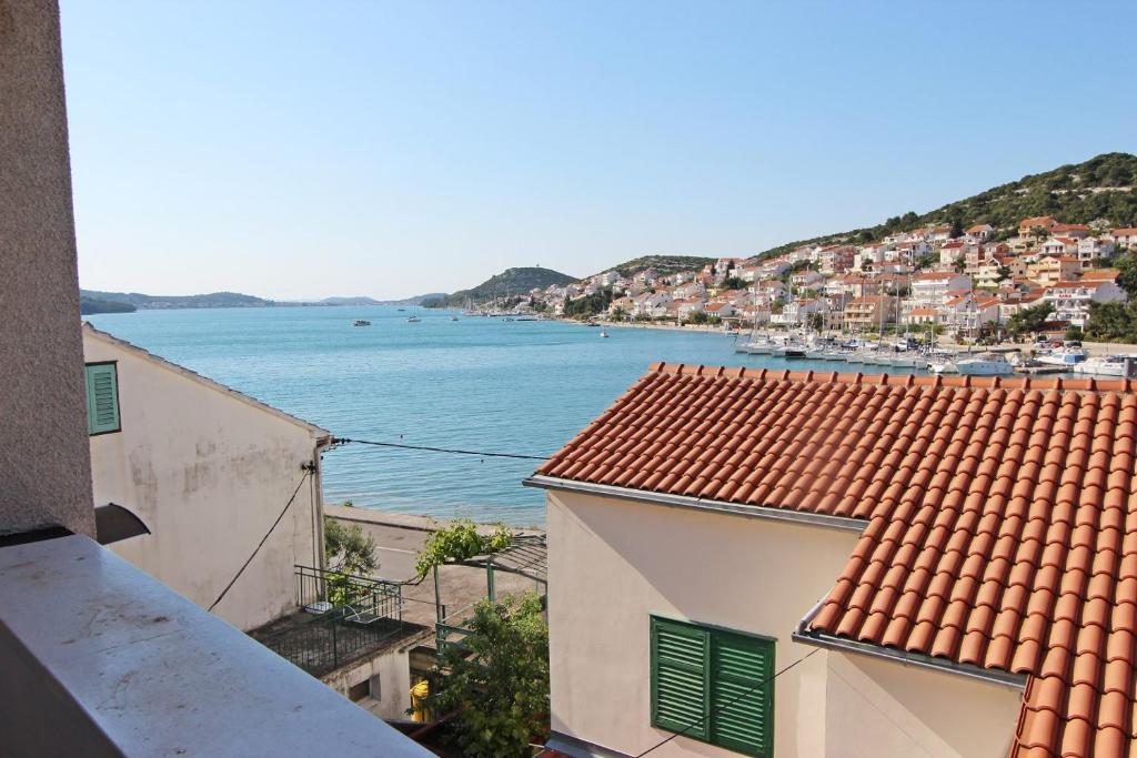 a view of a harbor with houses and the water at Apartment Laura in Tisno