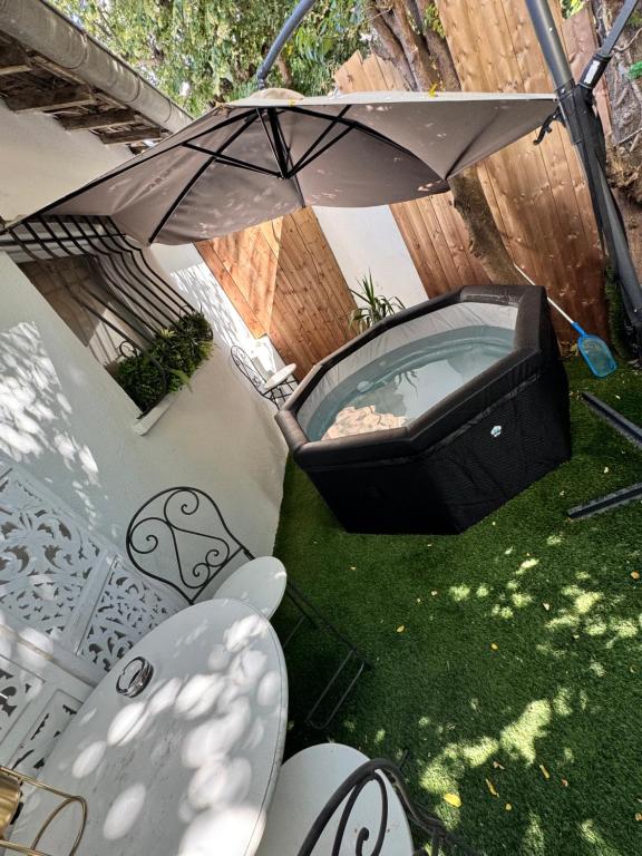 an overhead view of a hot tub and an umbrella at Modern suite with jacuzzi in Toulon