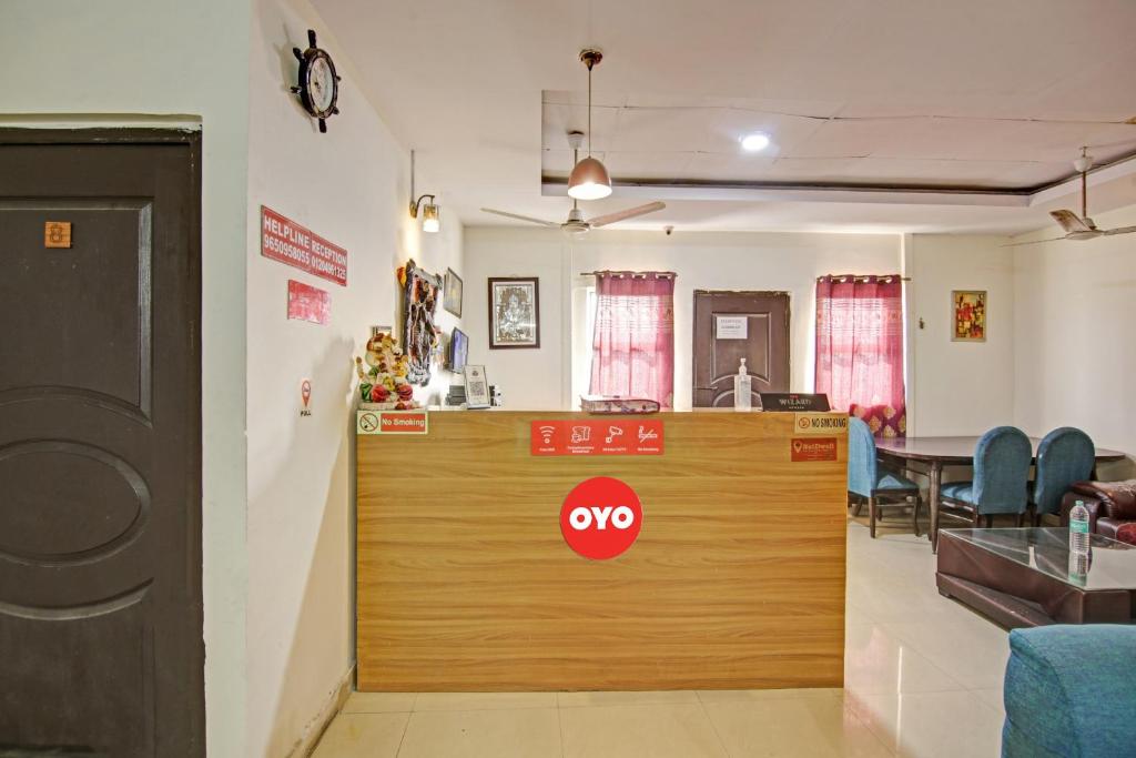 a restaurant with a wooden counter in a room at Super Hotel O Glorious Stayz in Noida
