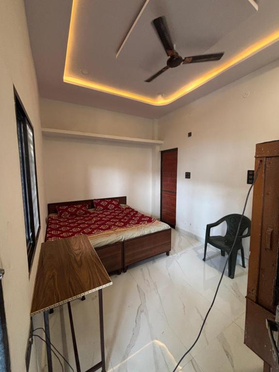a room with a bed and a chair in it at Hotel Ashish in Kaohni
