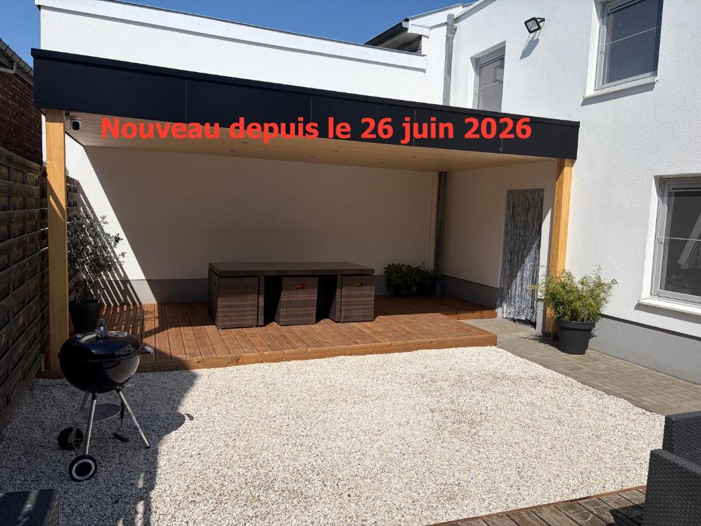 a building with a sign that reads novae condos ie july at Chez Kri in Limbourg