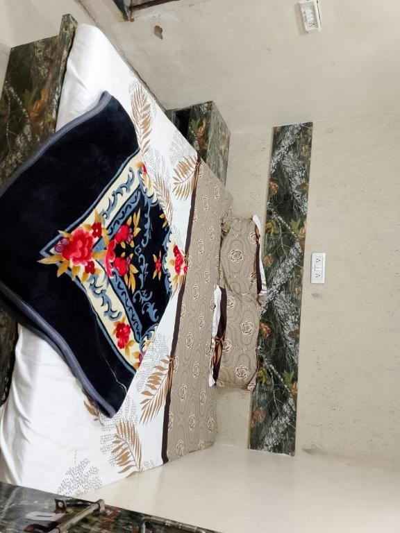 a shirt and tie sitting on top of a bed at Radha rani sadan in Vrindāvan