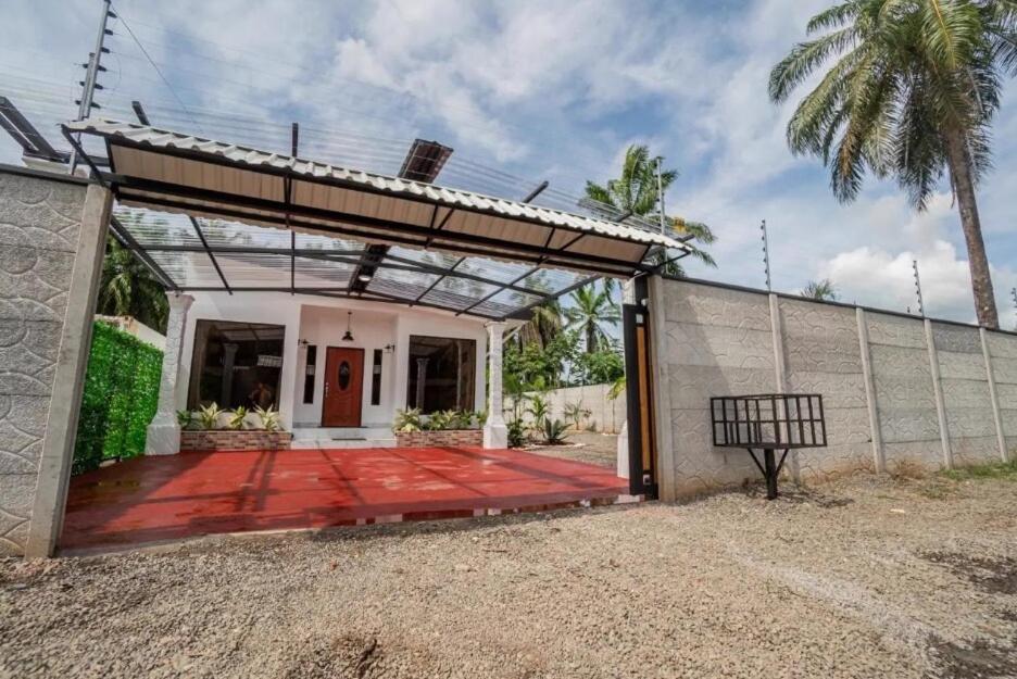 a house with a glass door and a patio at Lions Houses in Parrita