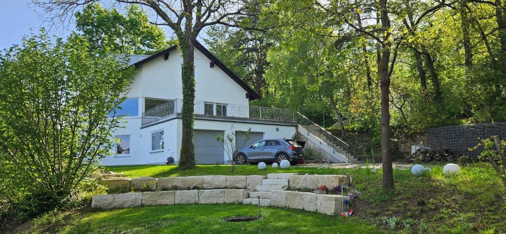 a car parked in front of a white house at Ferienhaus Panoramablick Altfalter in Schwarzach bei Nabburg