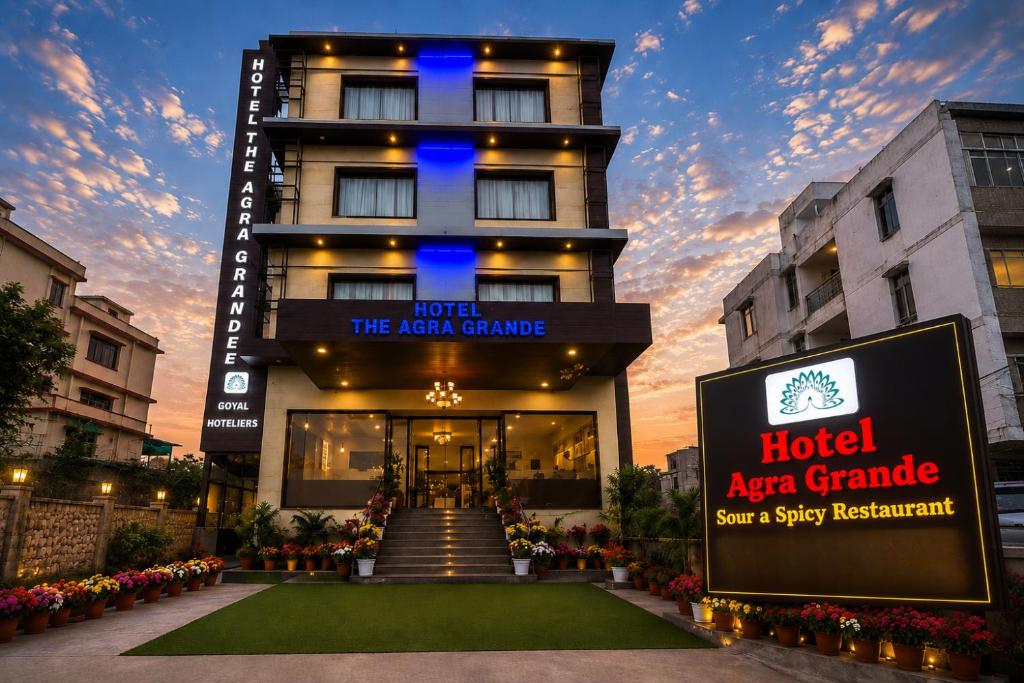 a hotel with a sign in front of a building at Goyal Hotelirs - Hotel The Agra Grande, Agra in Agra