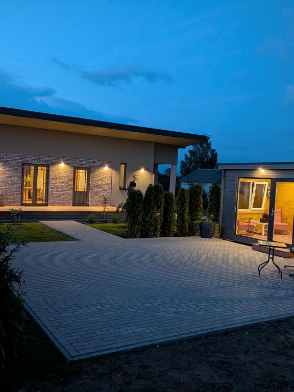 a house with a driveway in front of it at Zaķēni in Āboliņi