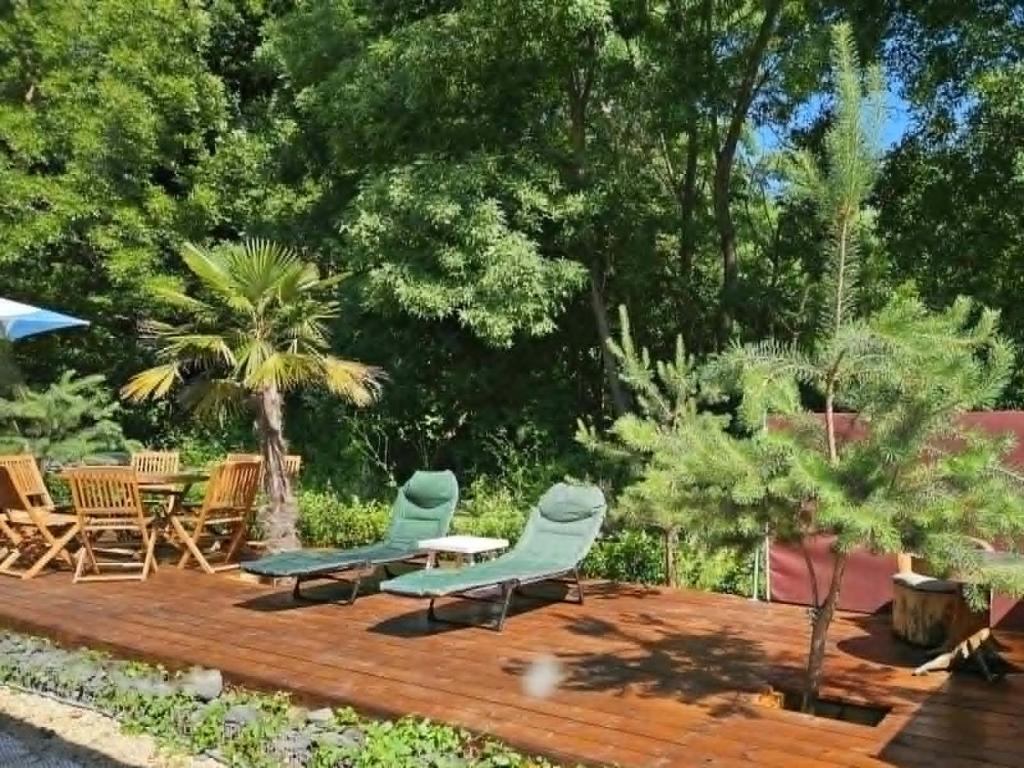 a deck with two chairs and a table and chairs at Ах, морето !!! in Tsarevo