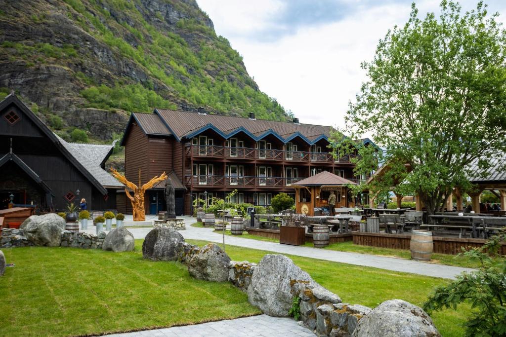 a resort with a mountain in the background at Flåmsbrygga Hotel in Flåm
