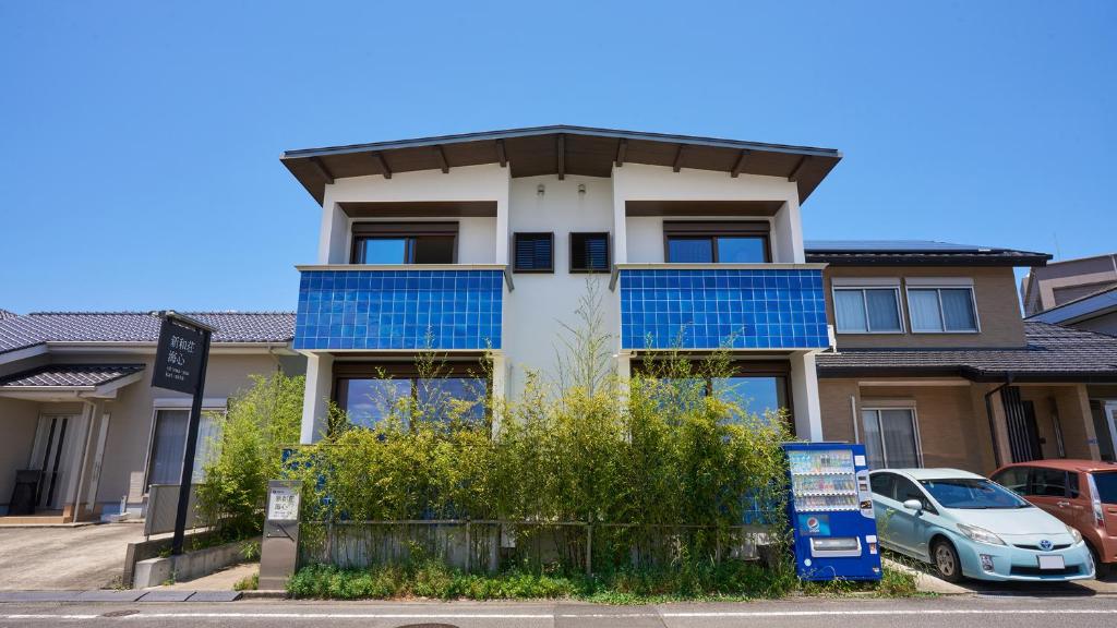 a house with blue tiles on the front of it at Shinwaso Kaishin in Amakusa