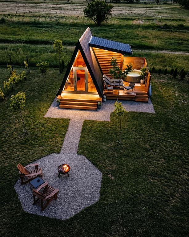 an overhead view of a small cabin in a field at Honey Glamping Resort with jacuzzi in Tomislavgrad