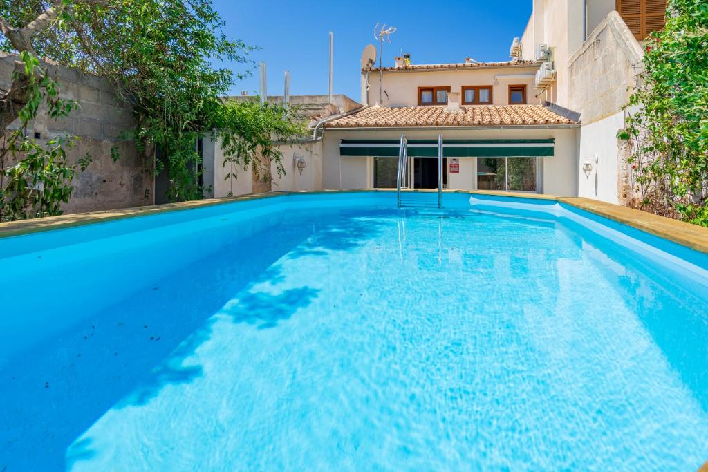a large blue swimming pool in front of a house at Sant Antoni 39 in Llucmajor