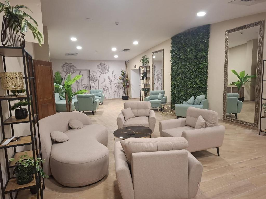 a waiting room with couches and chairs and a mirror at Hotel Darina Select in Târgu-Mureş